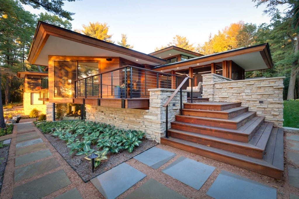 exterior of a brown and stone modern home at sunrise