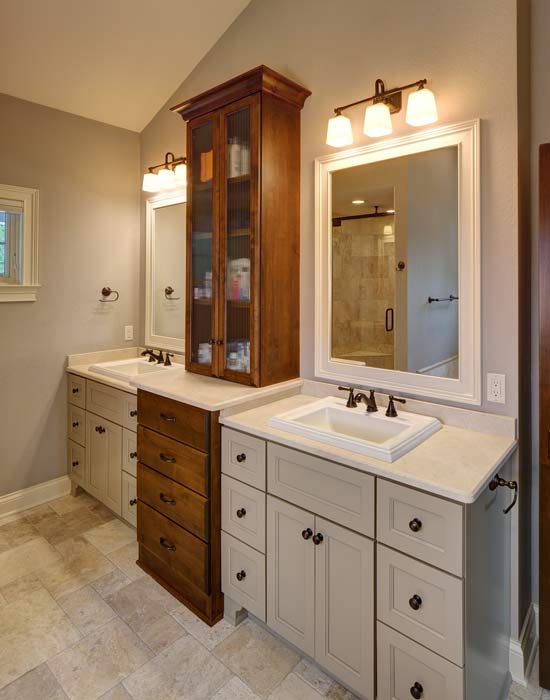 picture of a white master bathroom with two sinks and mirrors