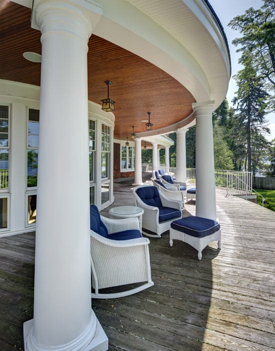 picture of a veranda with blue wicker chairs