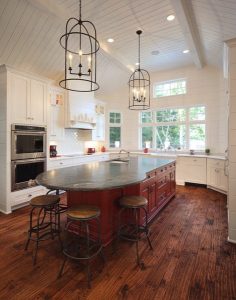 picture of a kitchen with wooden floors and island with a black countertop