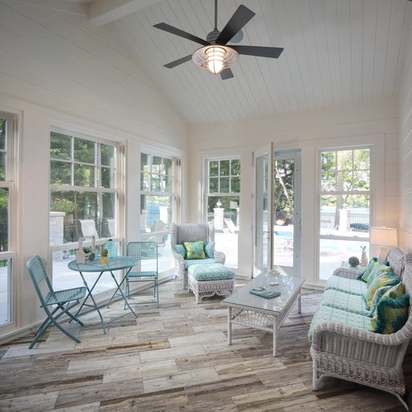 picture of a porch with seating and a ceiling fan and light
