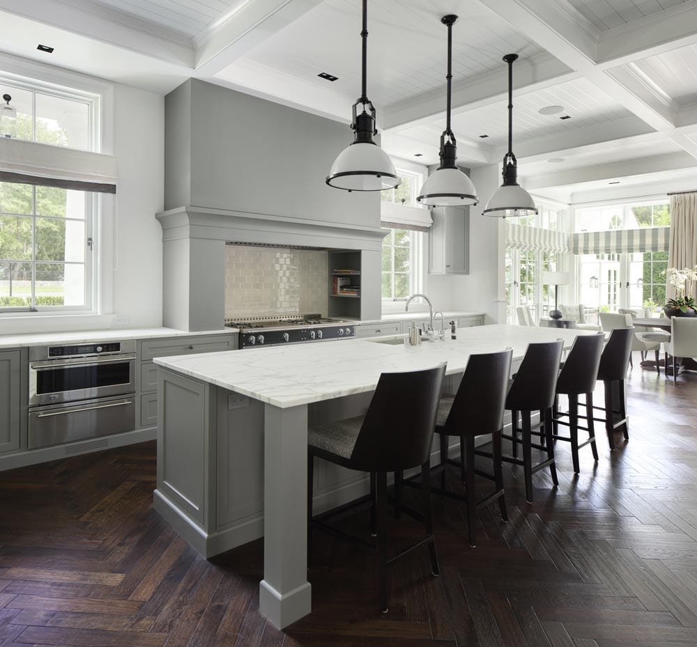 picture of a gray kitchen with wooden floors