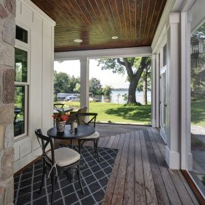 picture of an outside porch with a table and two chairs