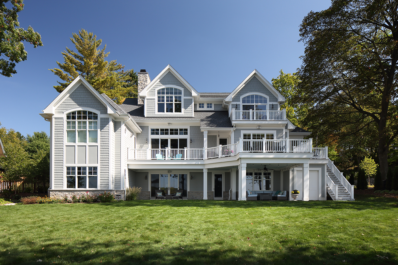 picture of a gray home with a long balcony