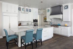 picture of a white kitchen with blue chairs