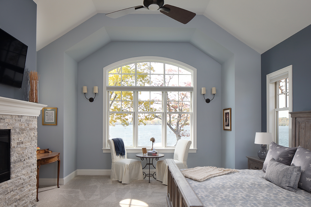 picture of a blue bedroom with large window
