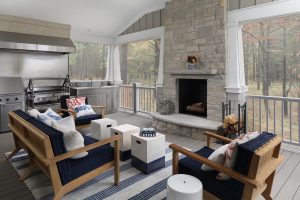 picture of a porch with a fireplace and seating