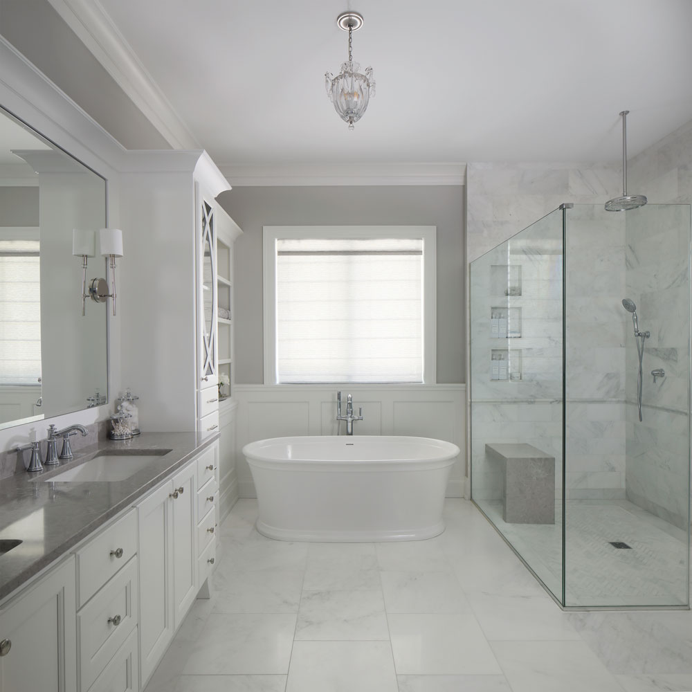 white master bathroom with a bath tub and walk in shower